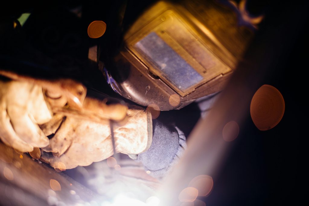 pexels photo 2950117 2950117 Close-up of a welder working with sparks flying, highlighting industrial craftsmanship.