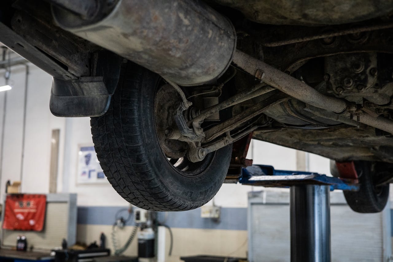 Avaleht Close-up of car's undercarriage in a service station for repair and maintenance.